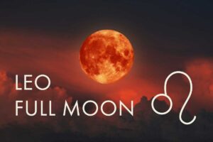 Fiery full moon hovering over clouds on a black background, Full Moon in Leo blog post