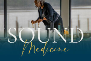 Photo of a black woman playing crystal bowls for a sound healing training for GlassWing Medicine