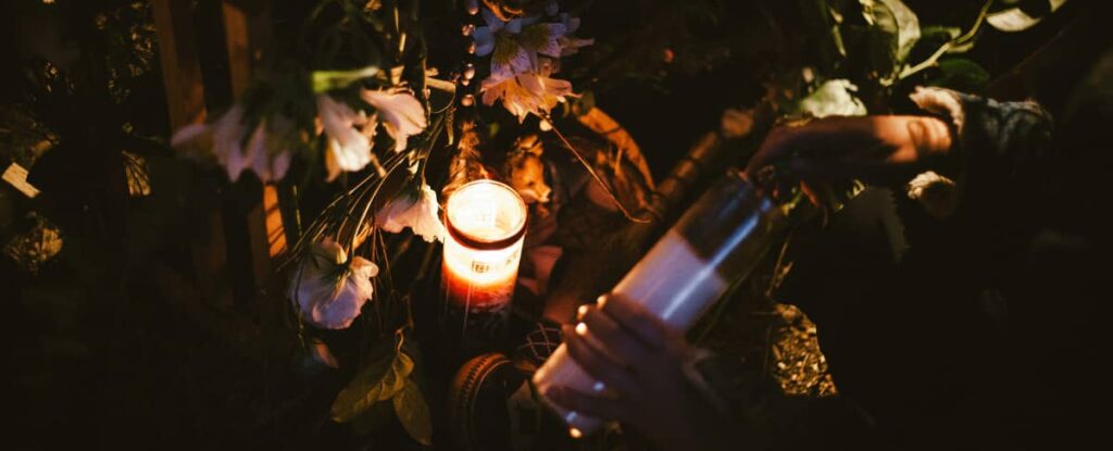 Image of Angela lighting a candle for a ritual